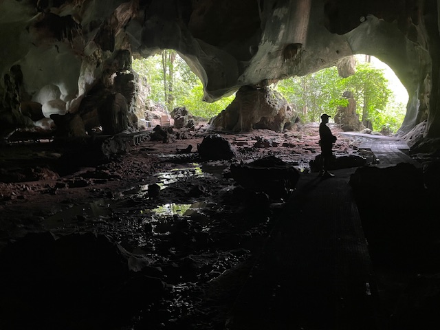 Interior of Gua Bama's main circular chamber showing natural limestone formations and cathedral-like space