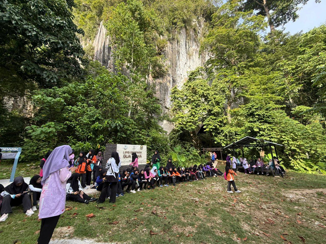Educational geological tour at Gua Bama showcasing limestone formations