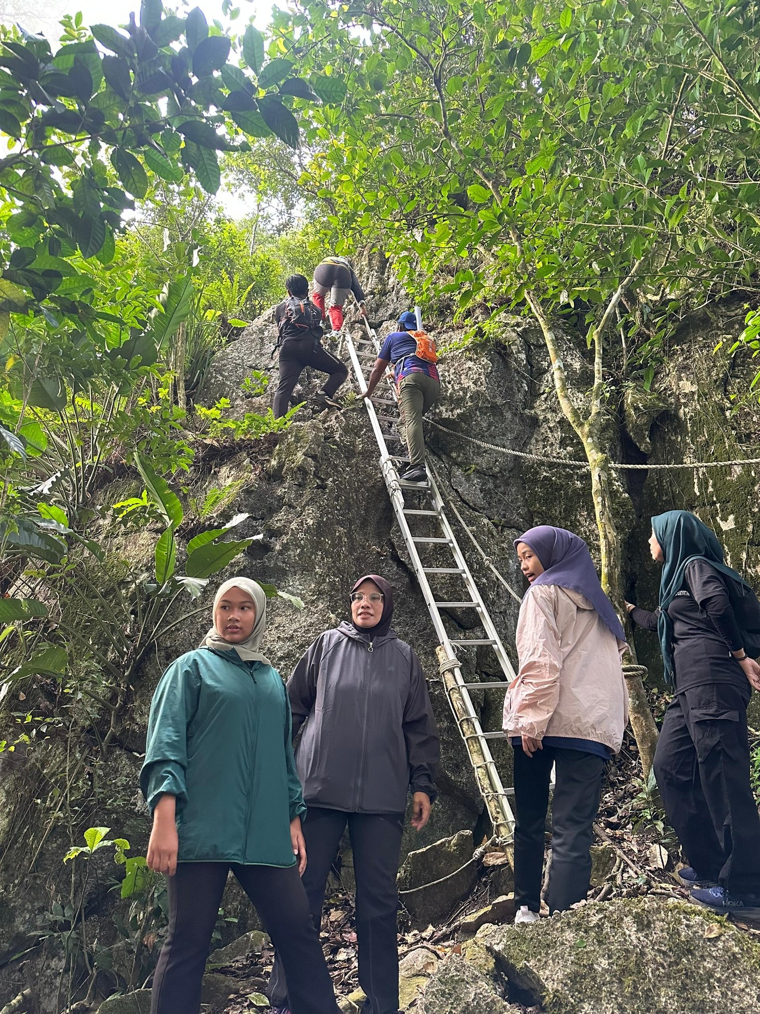 Hiking trail ascending through limestone terrain at Gua Bama, Kuala Lipis